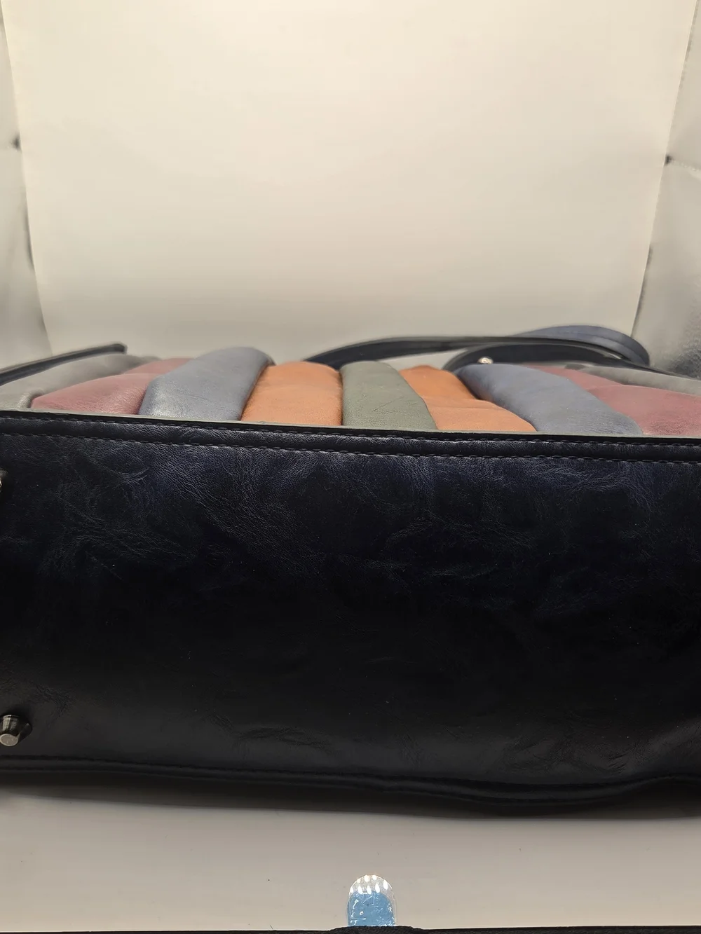 Shopper tote bag made of narrow strips of black, brown, and red leather